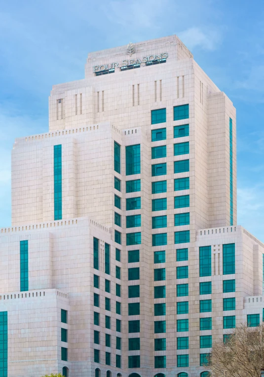 the front of an office building against a bright blue sky