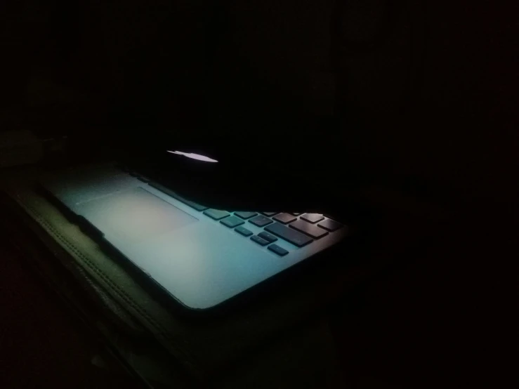 a light is shining on a computer in the dark