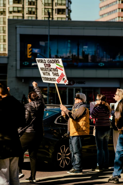 some people holding protest signs in the street