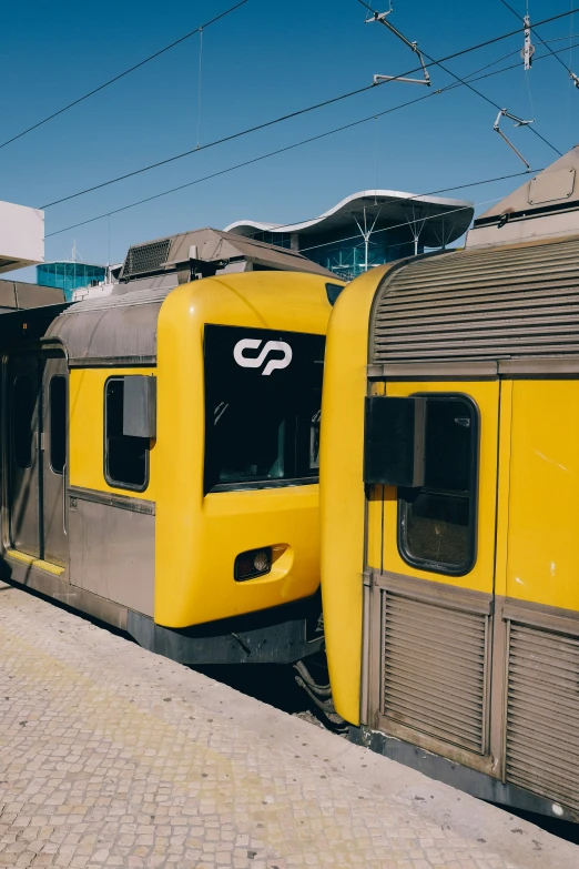 a yellow train parked at a platform