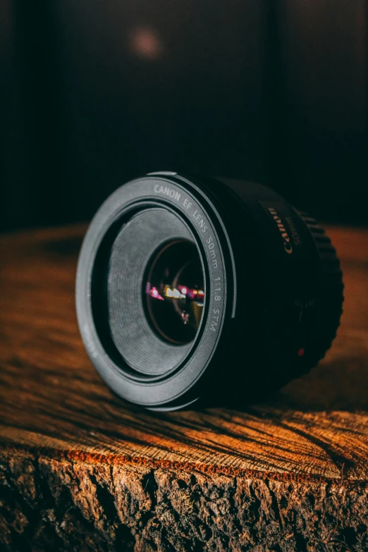 a small camera lens resting on top of a piece of wood