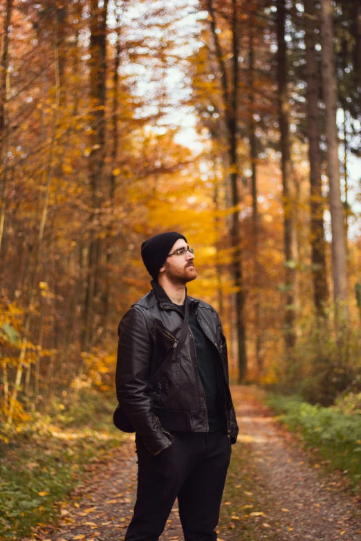 the man is standing in the middle of the forest