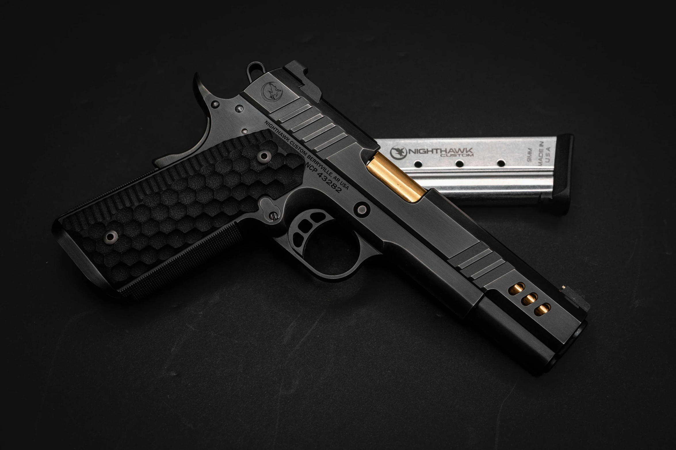 the pistol is displayed with its gold and black grip