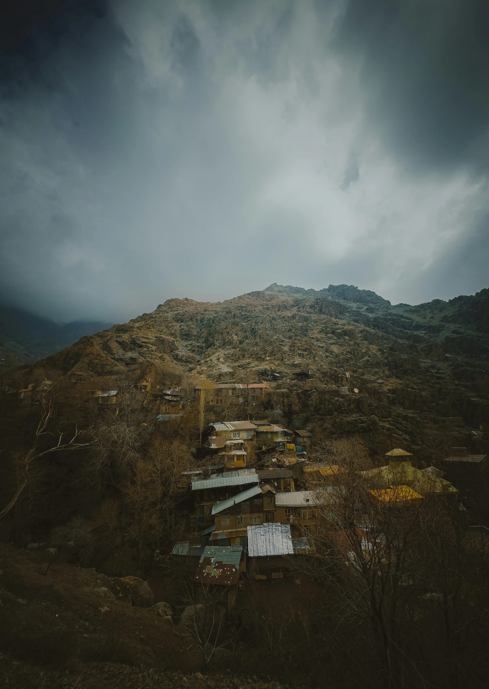 cloudy and ominous skies above a small village