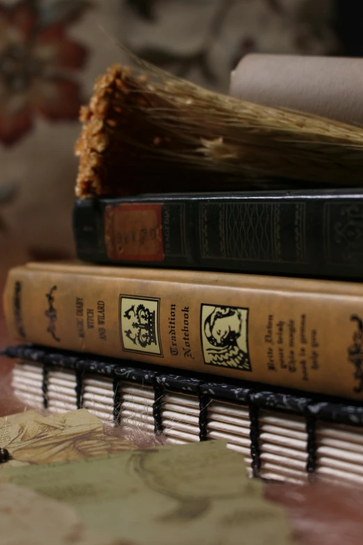 two books and an open book on top of a table