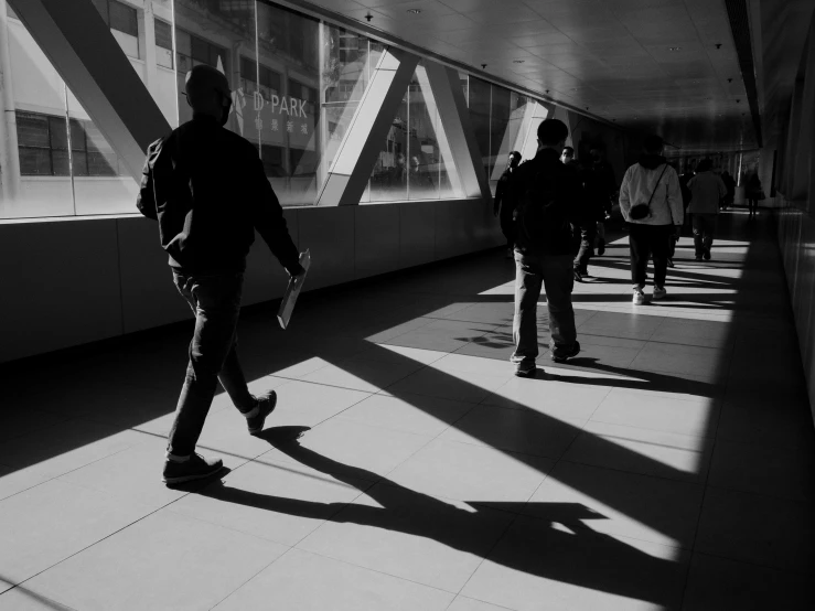 a group of people walking across a bridge