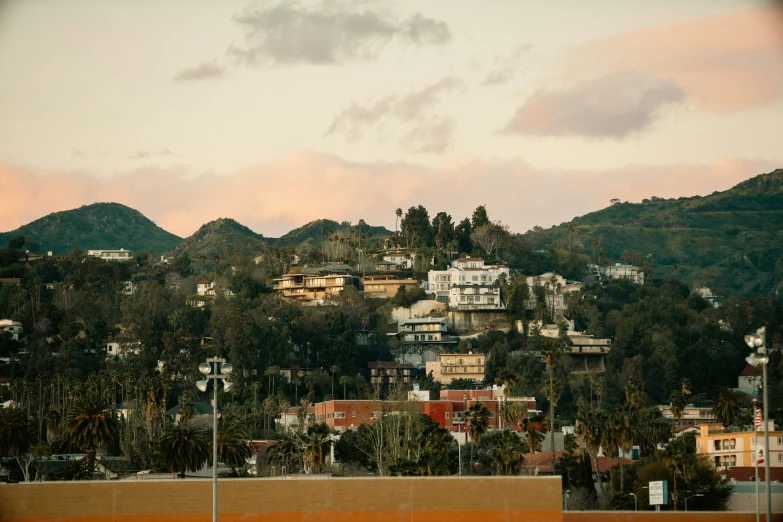 a city sits atop a mountain in the distance