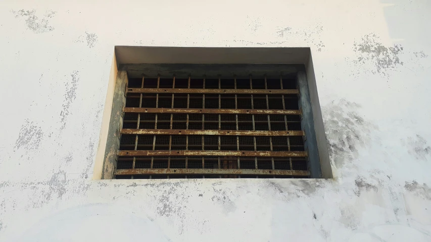 a window that has some brown bars on it