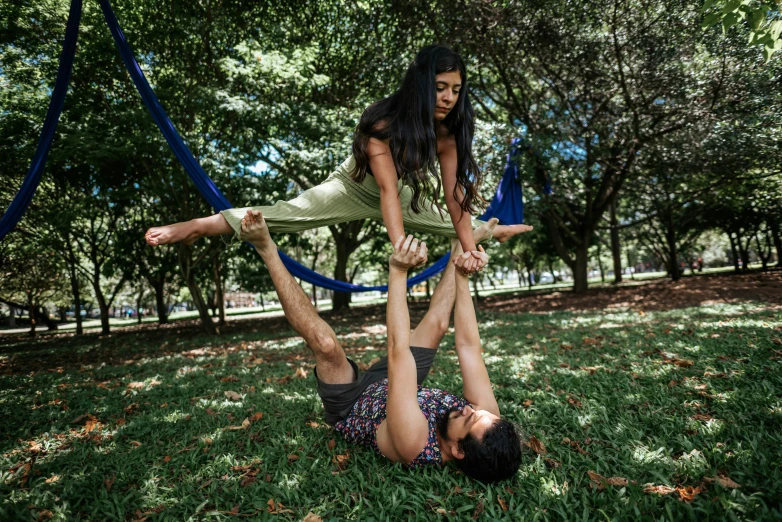 two children playing on a rope in the park