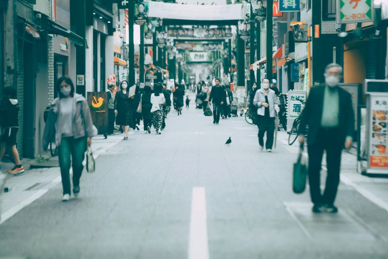 some people walking down an alley way with shops