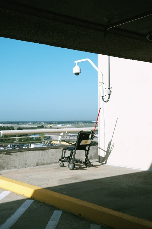 the view from a corner with a chair sitting outside