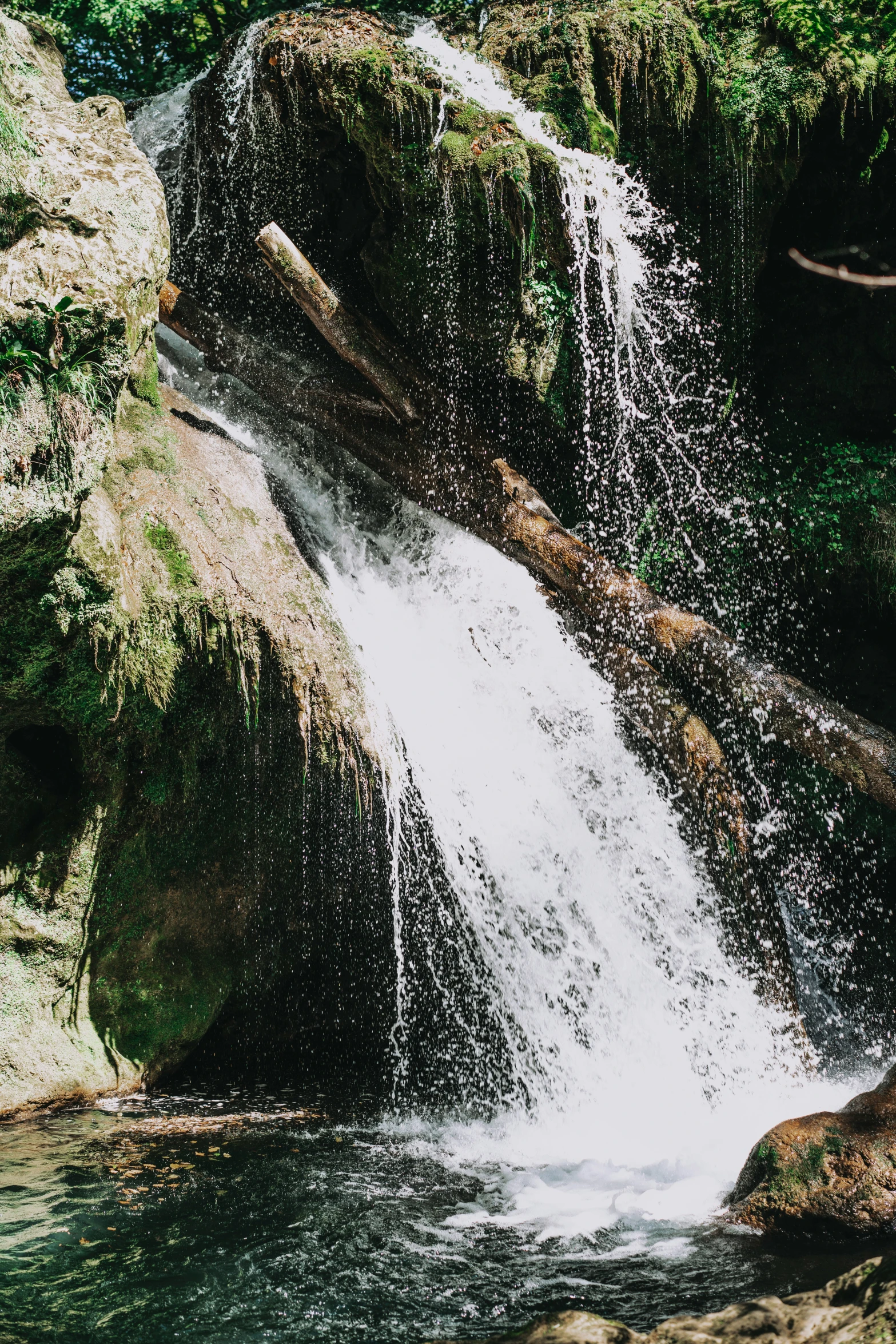 a waterfall in the middle of some rocks