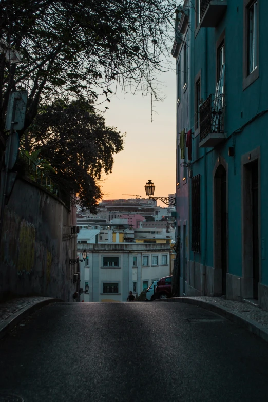 the dark alley way between two buildings with graffiti painted walls