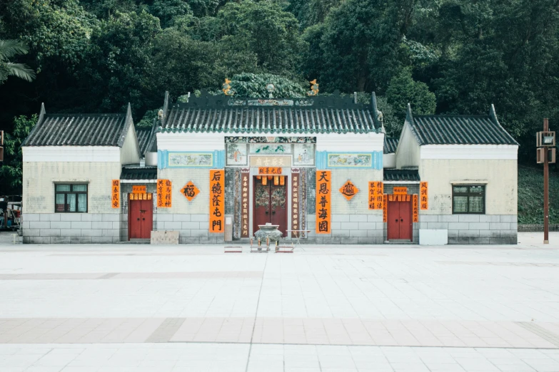 a large building with many doors that has orange chinese writing on them