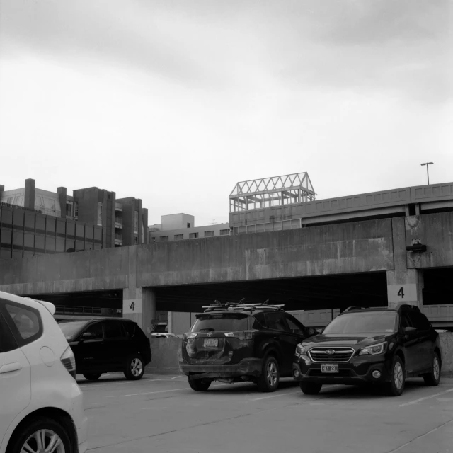 cars are parked on the side of a road near an empty parking lot