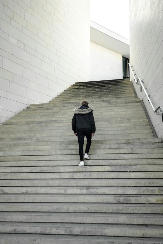 a man walking up some steps with his feet down