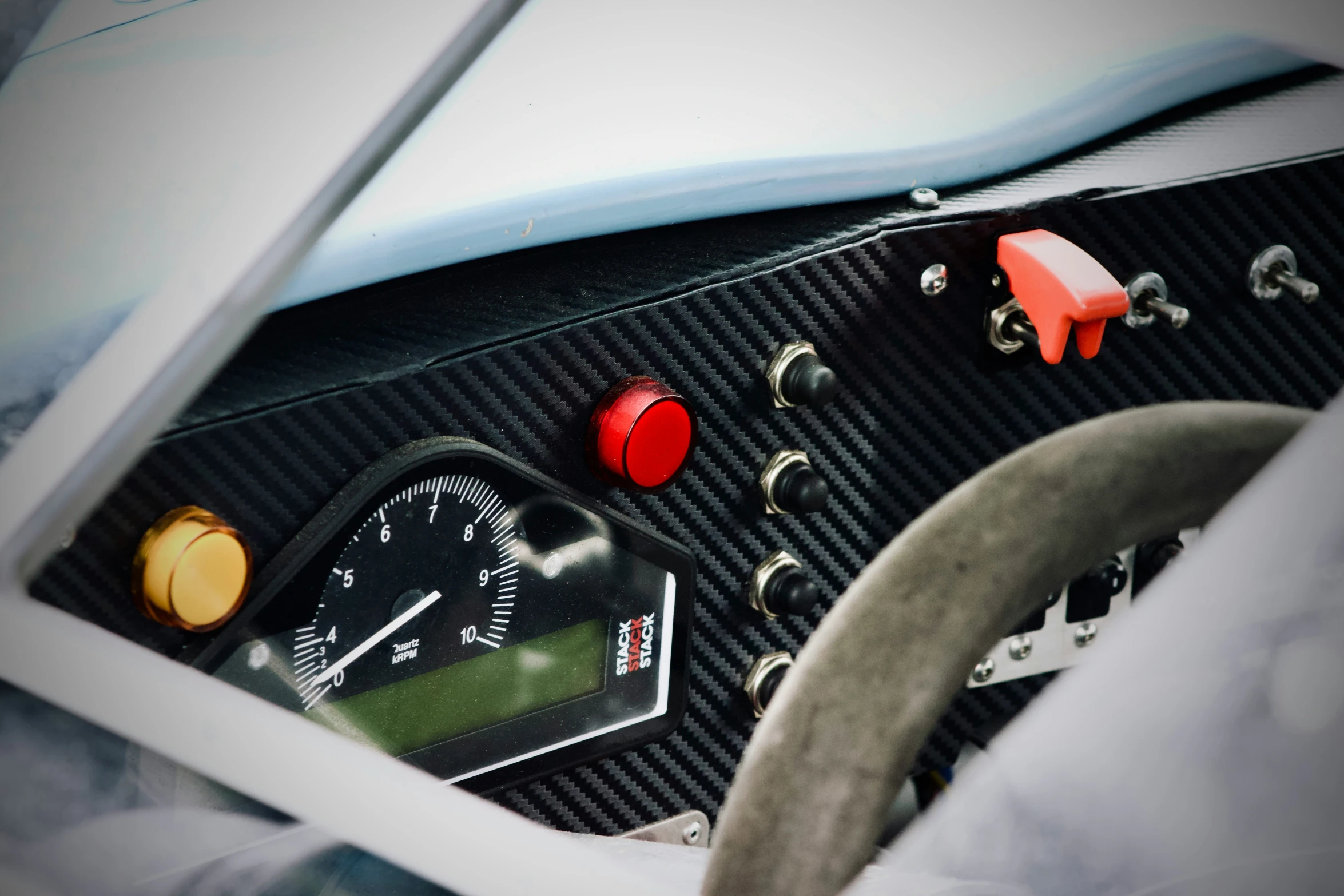 a picture of some car dashboard, dashboard gauges and steering wheel