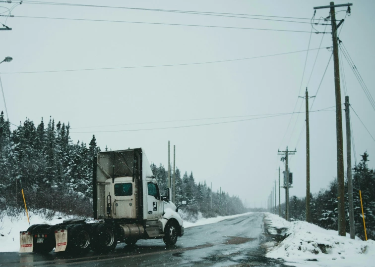 a big rig hauling equipment to the side of the road