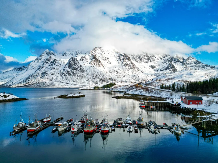 a view of the boatyard of a snowy mountain lake