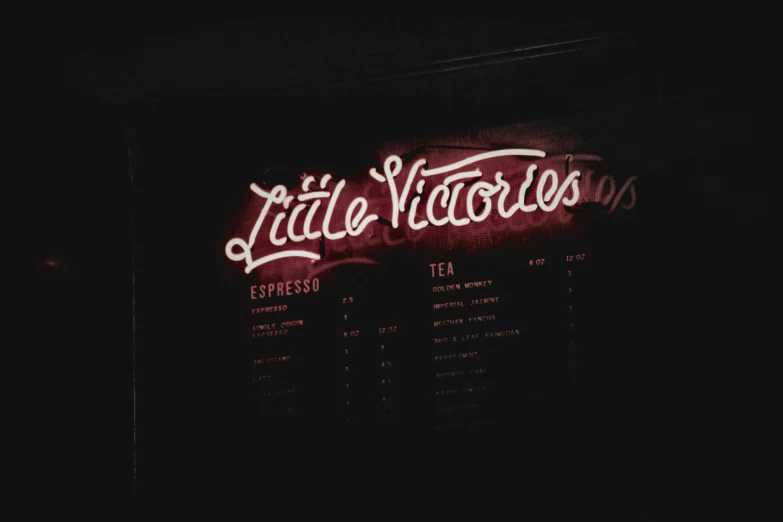 a menu sign in front of the restaurant at night