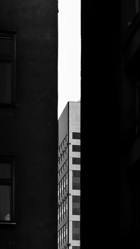an upward view of a building with windows in black and white