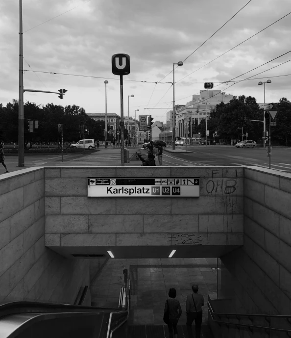 two people in the middle of the station as one person crosses