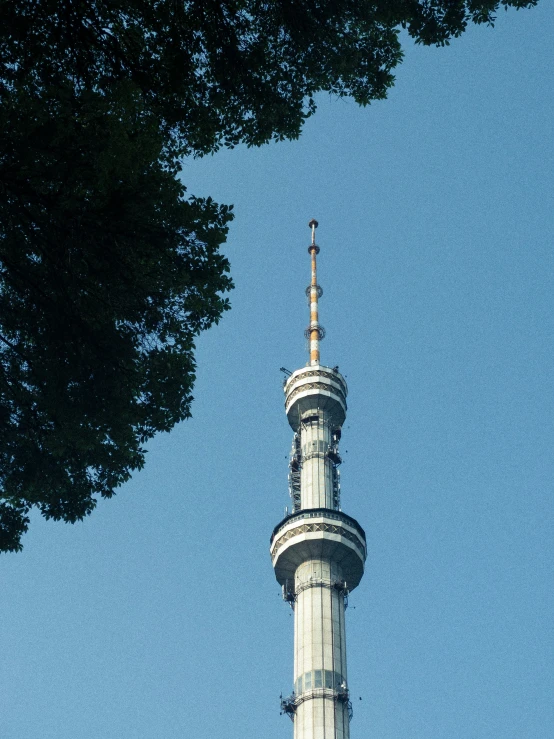 the spire of a white building with a black clock on it