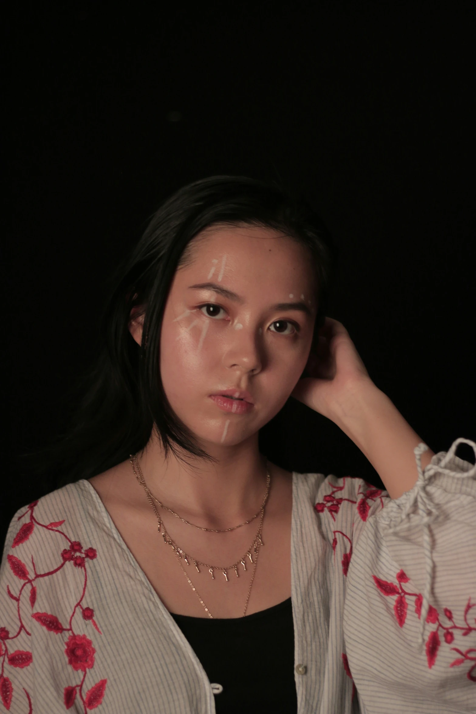 a woman with painted on face posing for a picture