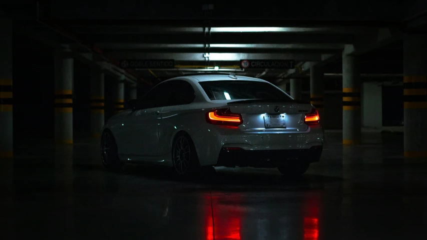 the car is in the parking garage at night