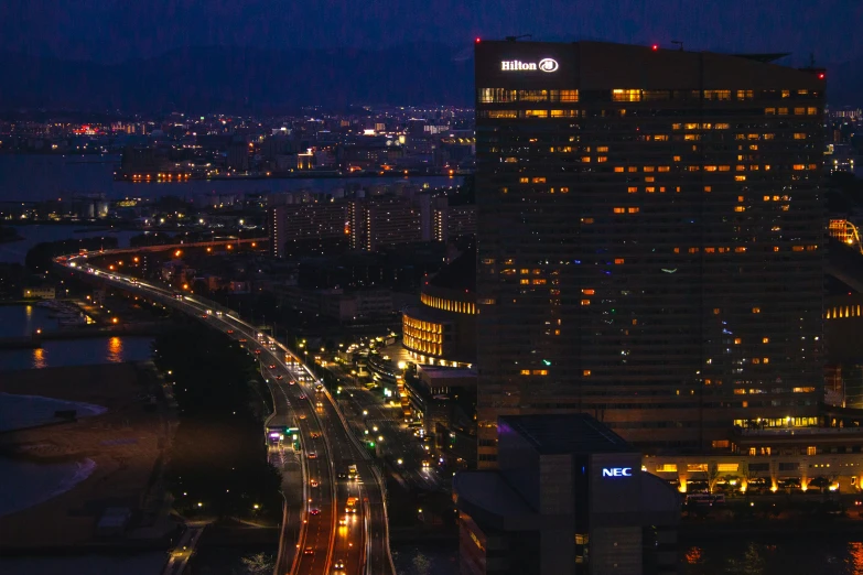 the night view of a street and an urban area in an illuminated city