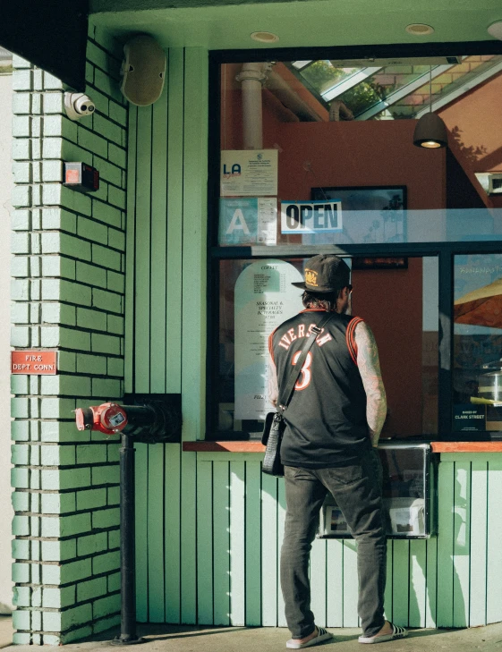 a person standing in front of a building and looking at their phone