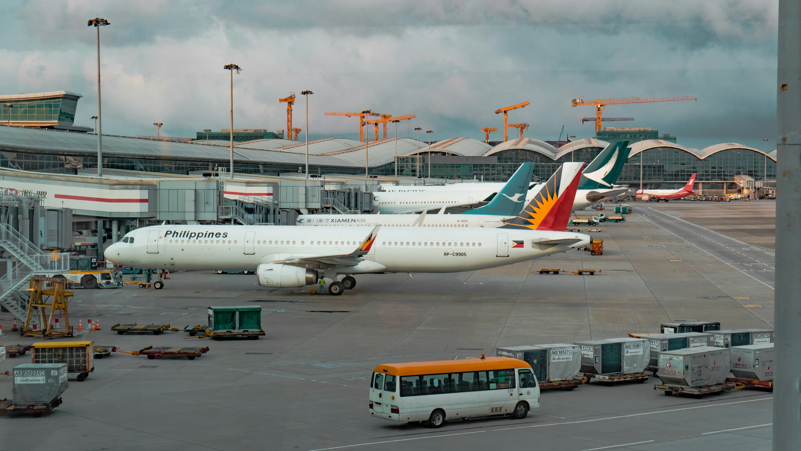 a number of large commercial airplanes parked at an airport