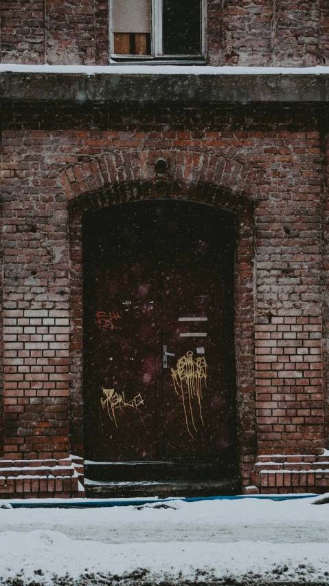 an old red brick building with a door in the front