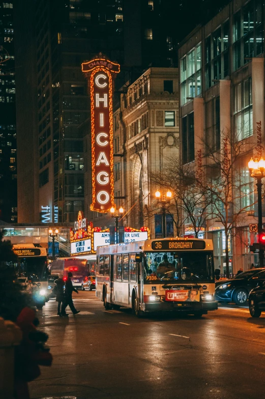 a busy intersection in a large city at night