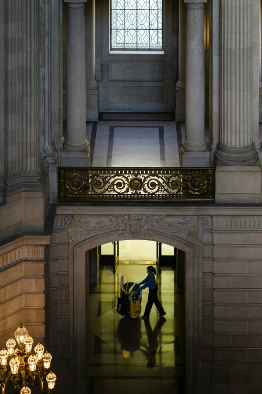 a building with a staircase and a person walking up to it