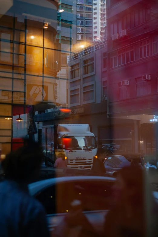 cars driving on the street with a traffic light in the middle of the street