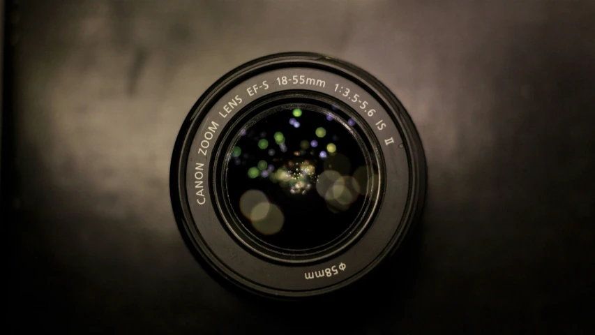a camera lens pointed up with the word zoom reflected in it