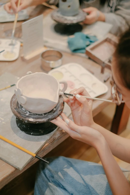 a woman is preparing a cup for a party