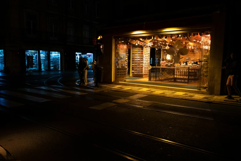 a store front on the side of a road at night