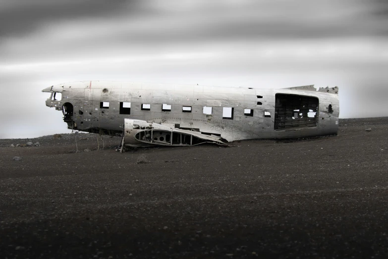 an abandoned airplane that is parked in the dirt