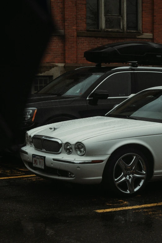 a white car parked next to a building