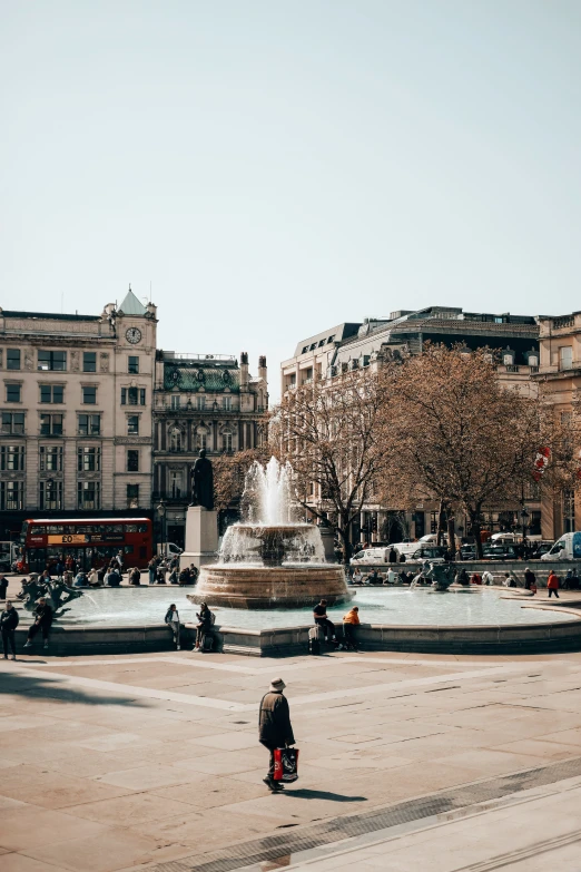 a view of a fountain in the middle of a city street