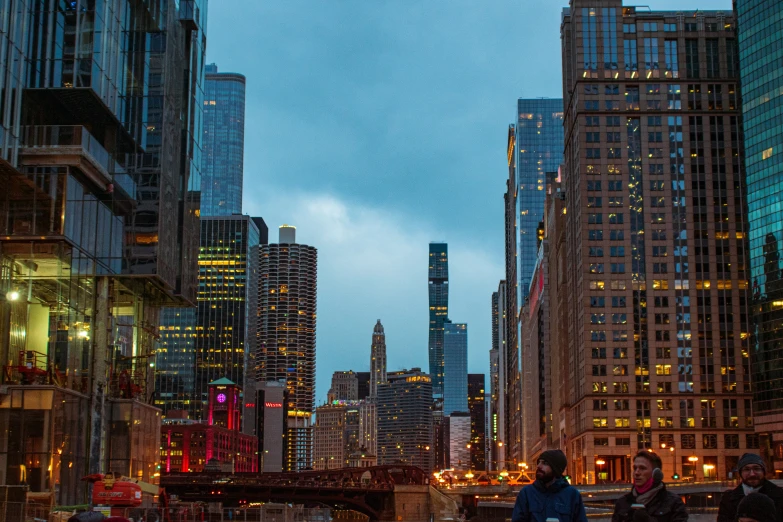 a group of people in the dark by buildings