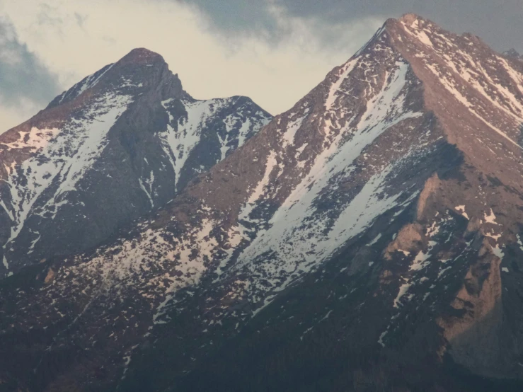 the mountains with snow on them in the daytime