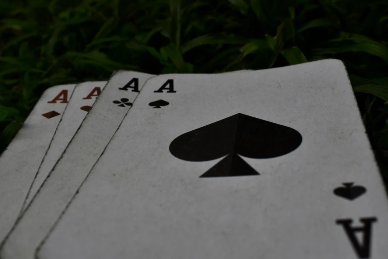 five playing cards are arranged in a close up pose