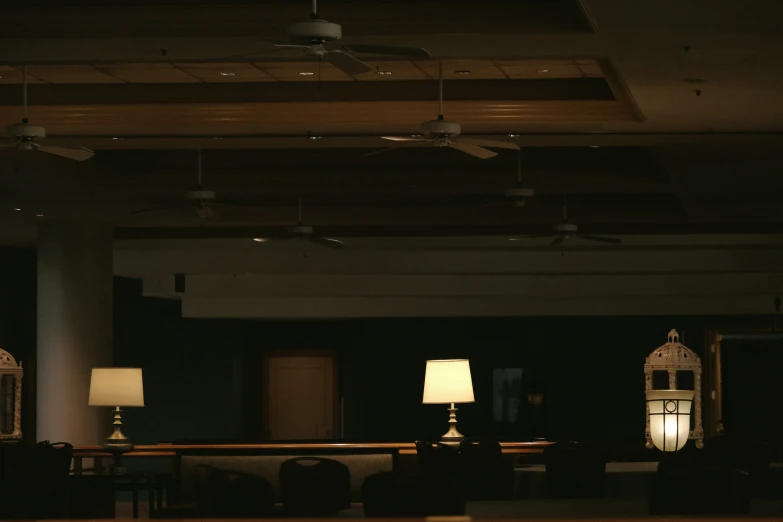 lamps and tables sitting at different heights in a dark room