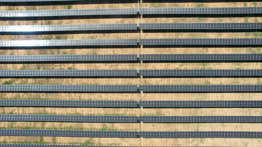 several rows of solar panels lined up against a wall