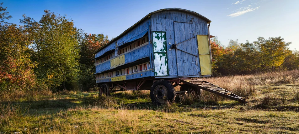 an old truck sits abandoned in the middle of nowhere