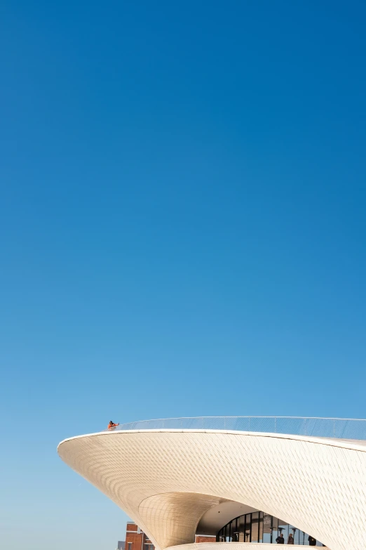 a building that has an airplane flying high in the air