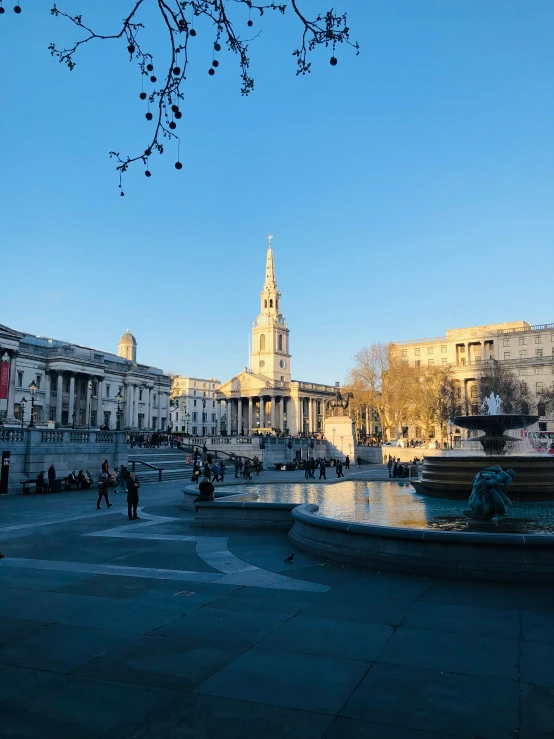 the city with people in the square is in a city